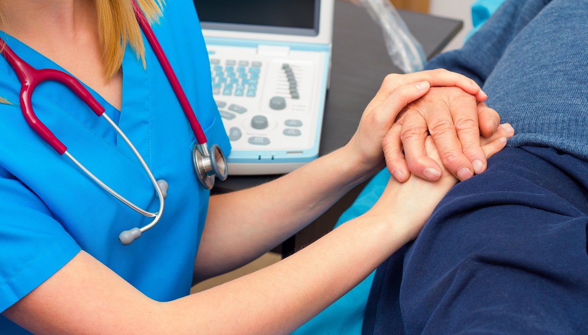 More than hospital care for elderly kind doctor giving real spiritual support for patient.